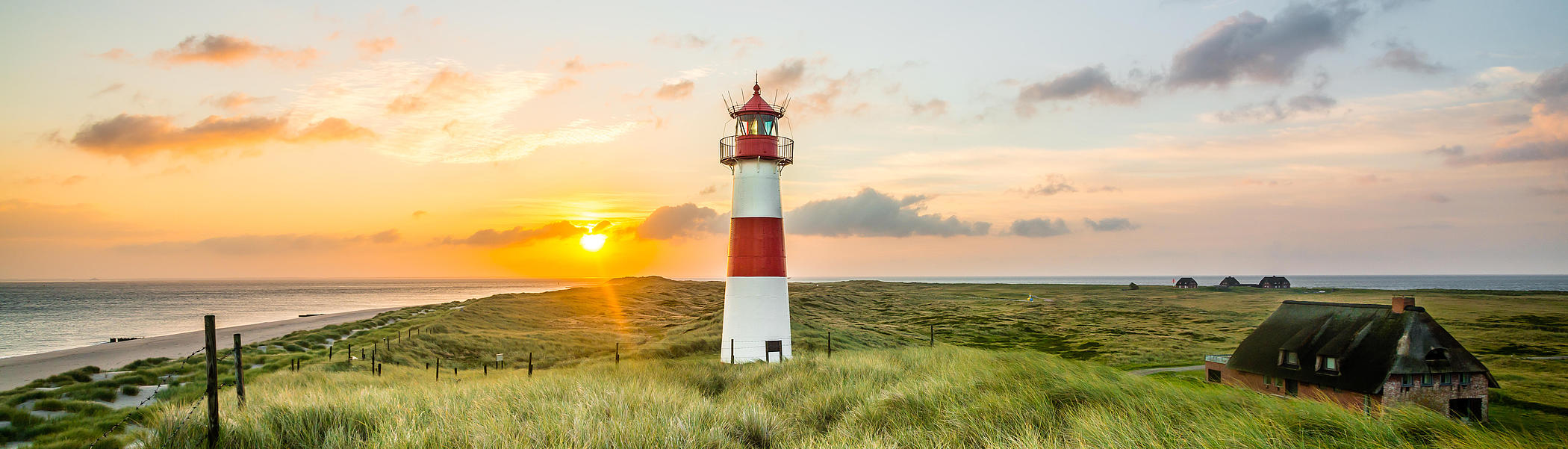 The lighthouse on Sylt’s Ellenbogen, with a sunset glowing in the background.