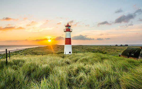 The lighthouse on Sylt’s Ellenbogen, with a sunset glowing in the background.