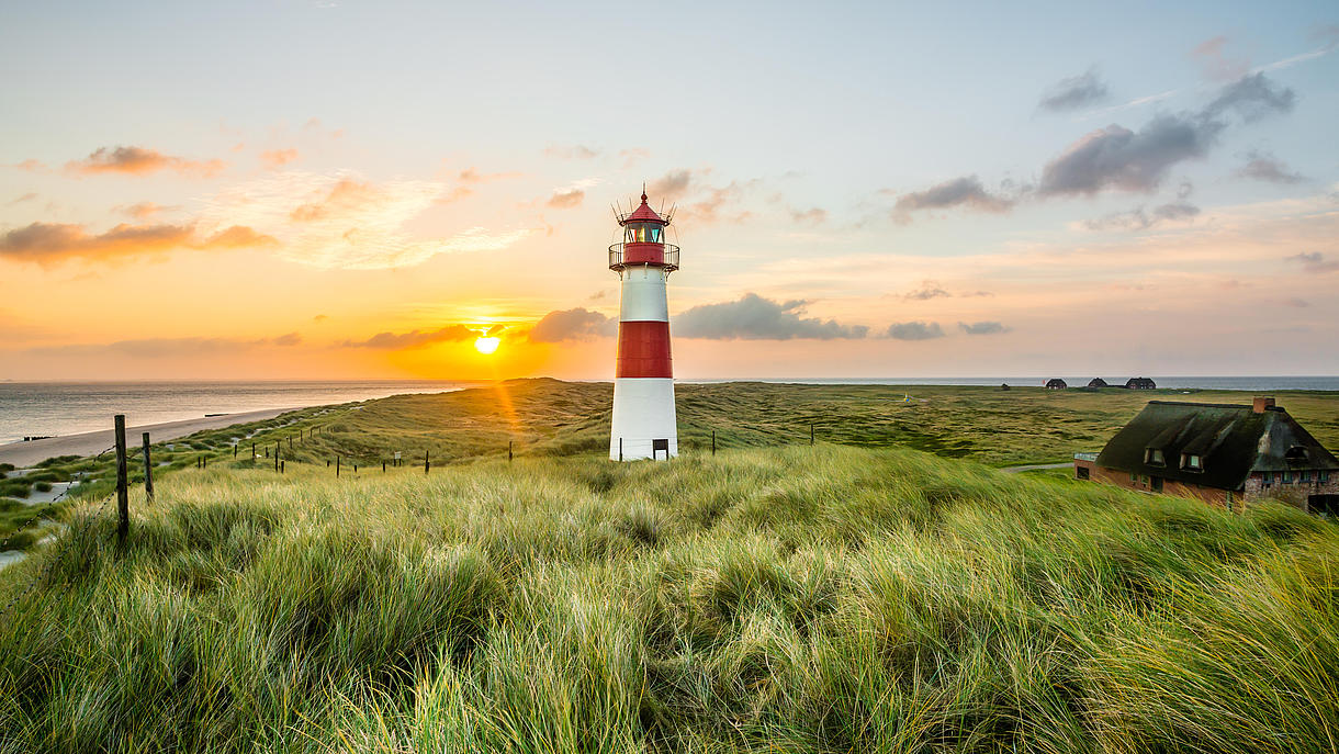 The lighthouse on Sylt’s Ellenbogen, with a sunset glowing in the background.