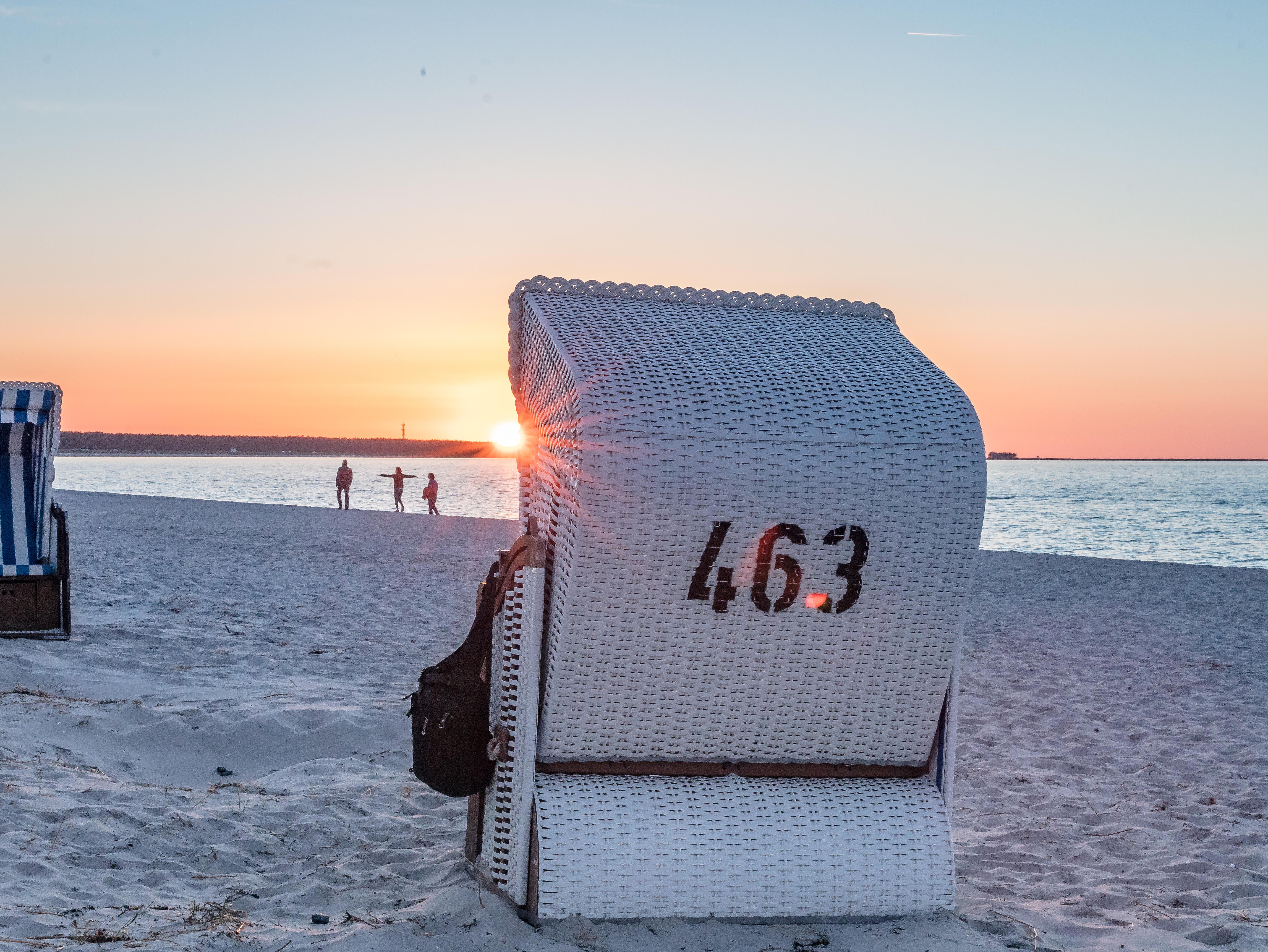 A beach chair on the beach at sunset