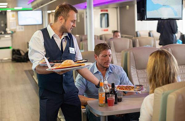 Steward handing out guest's gastronomic order on board