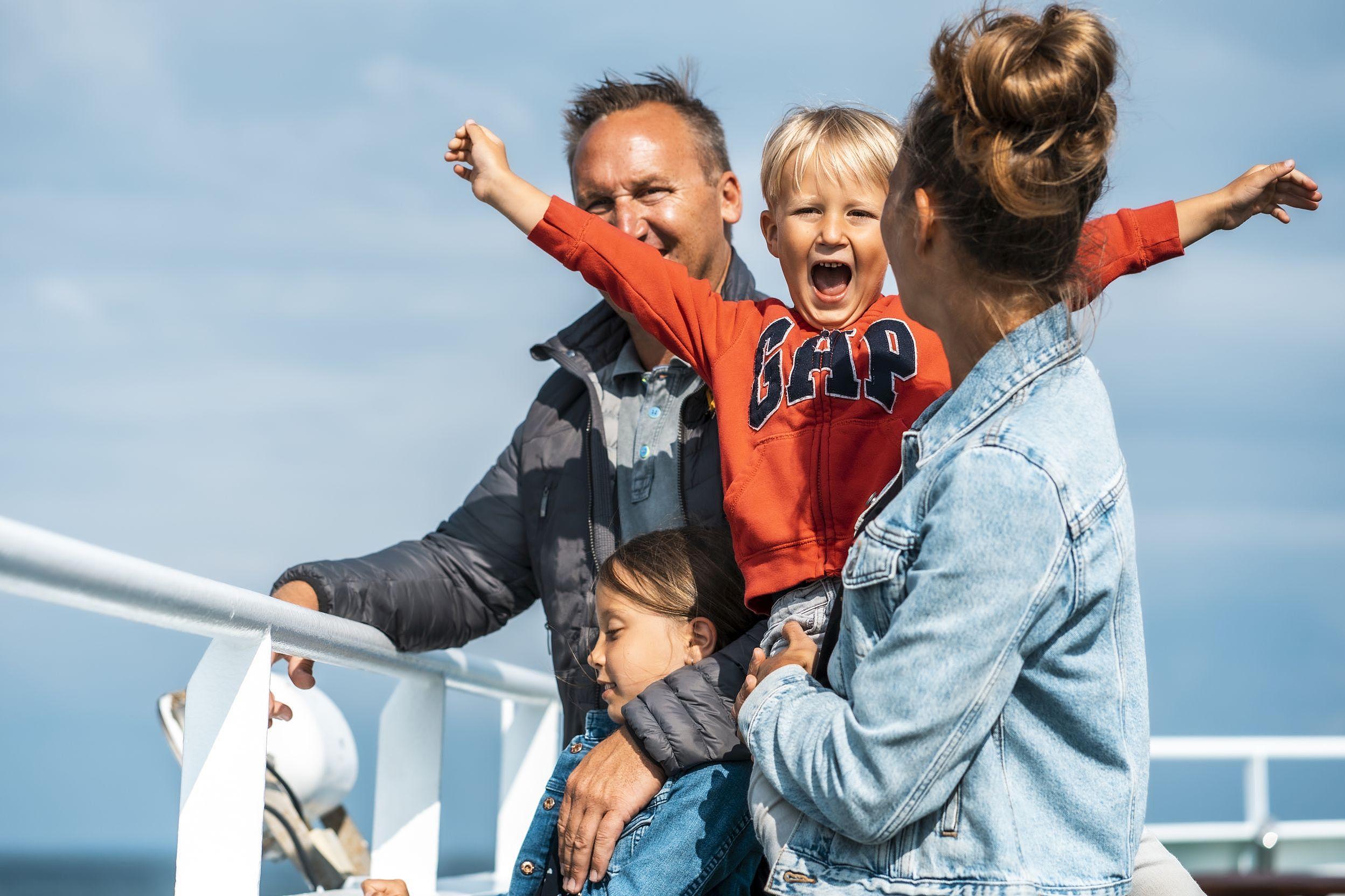 Cheering boy on his mothers arm