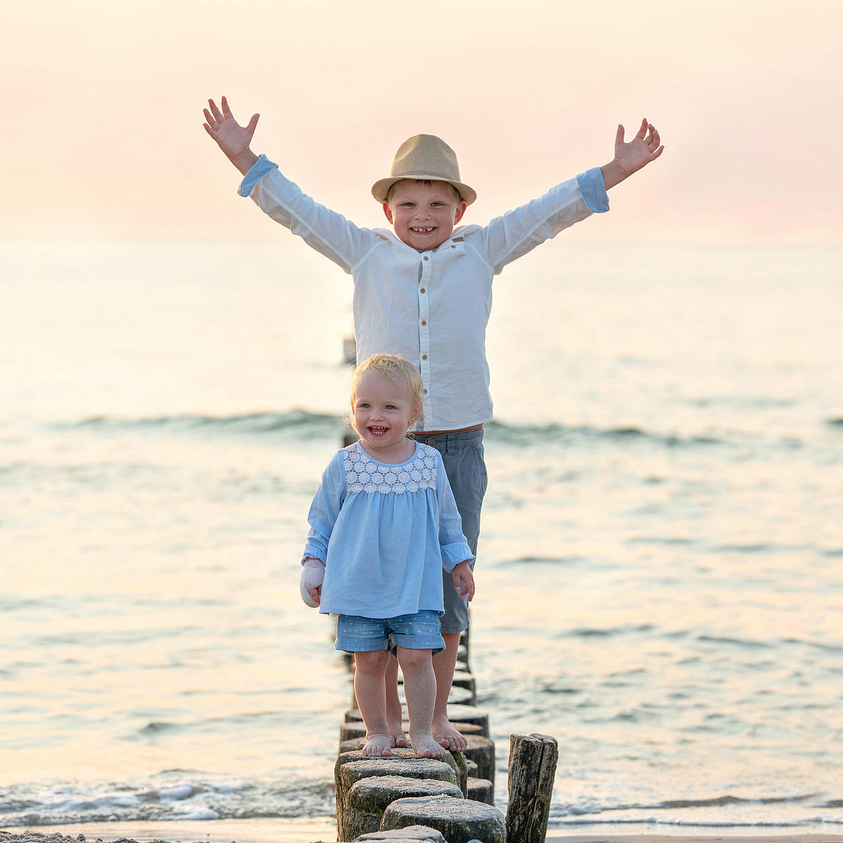 Two Children standing happily in the Water