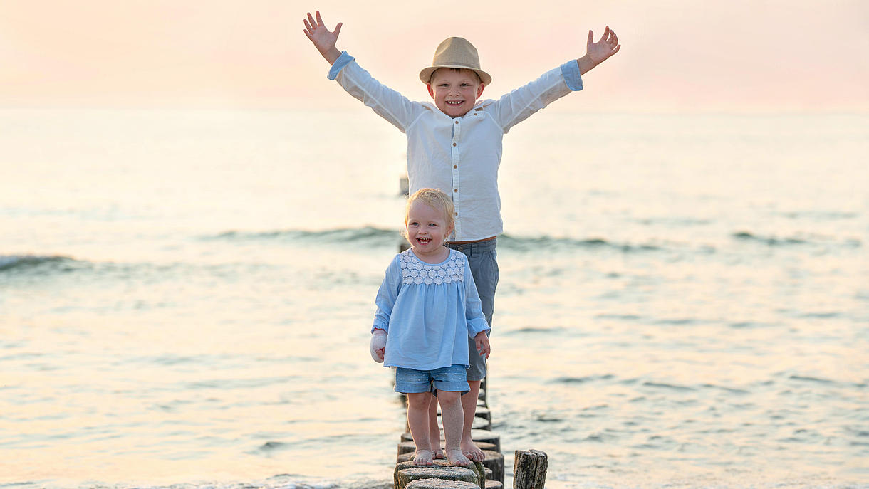 Two Children standing happily in the Water
