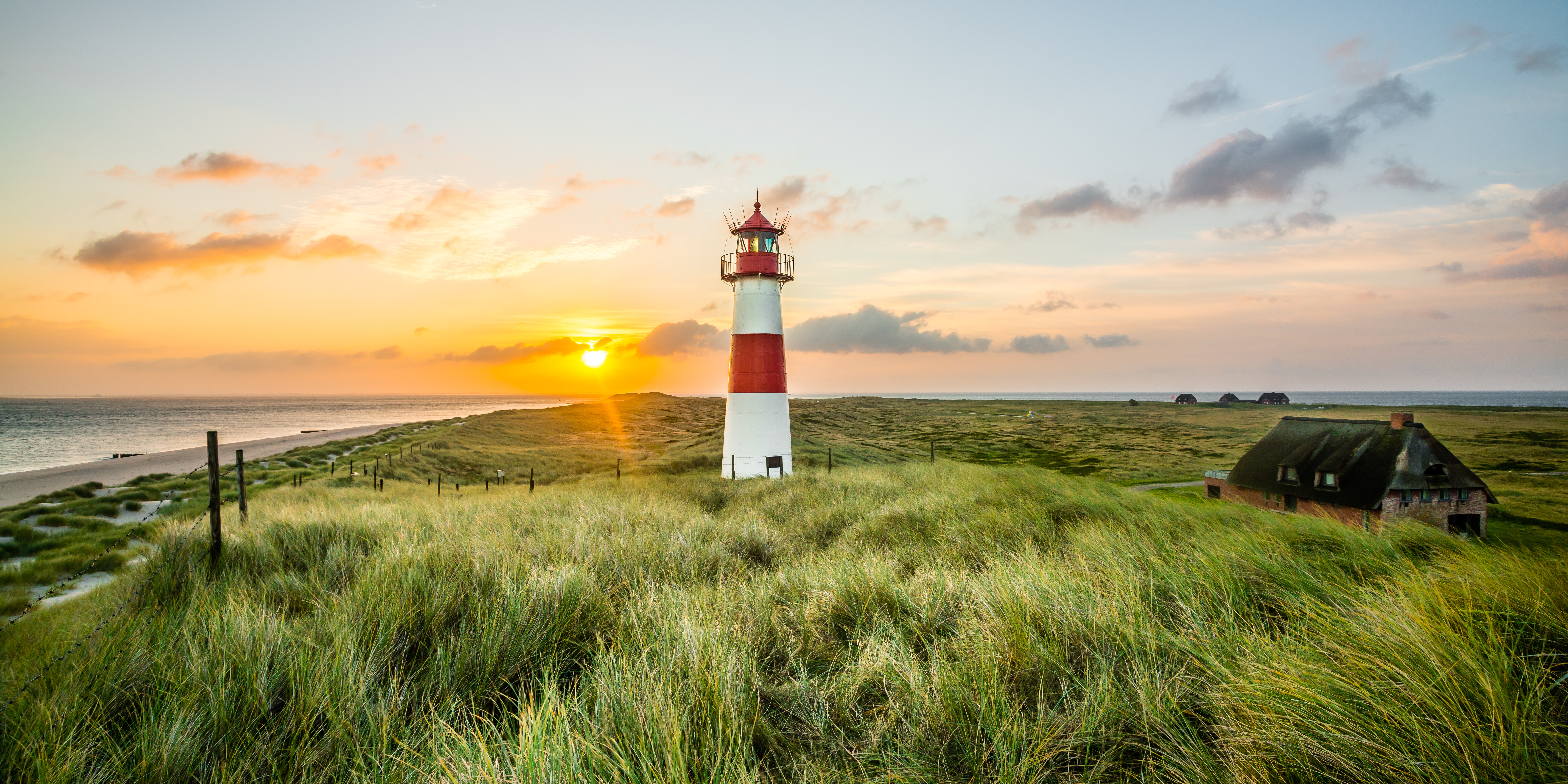 The lighthouse on Sylt’s Ellenbogen, with a sunset glowing in the background.